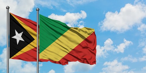 East Timor and Republic Of The Congo flag waving in the wind against white cloudy blue sky together. Diplomacy concept, international relations.