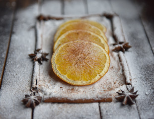 Christmas still life of dried oranges, cinnamon, star anise powdered sugar