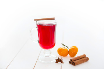 Mulled wine with cinnamon sticks on a white wooden background