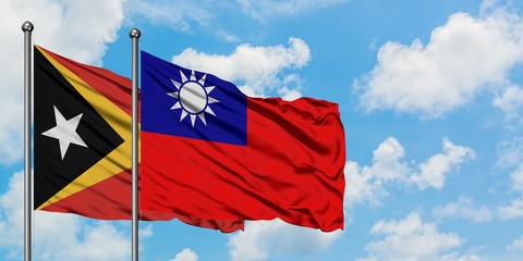 East Timor and Taiwan flag waving in the wind against white cloudy blue sky together. Diplomacy concept, international relations.