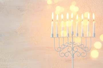 Religion image of jewish holiday Hanukkah background with menorah (traditional candelabra) and candles over white background