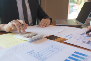 Businessmen, financial accountants, business planners, business planning ideas using computers, laptops, smat phones, and work calculators