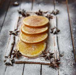 Christmas still life of dried oranges, cinnamon, star anise powdered sugar