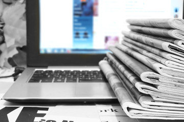 Newspapers and Laptop. Different Concepts for News - Social Network or Traditional Tabloid...