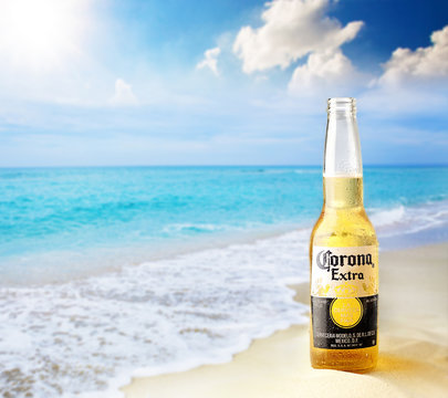 Kiev, Ukraine - February 10, 2017: Corona bottle at the beach with lime fruit ready to drink. Corona Extra is produced in Mexico and exported to all other countries all over the world.