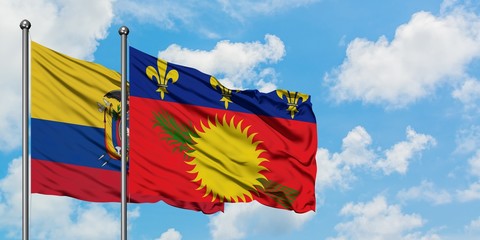 Ecuador and Guadeloupe flag waving in the wind against white cloudy blue sky together. Diplomacy concept, international relations.