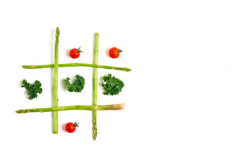tic tac toe with food, asparagus kale, tomato, top view