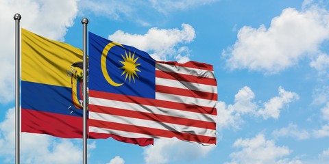 Ecuador and Malaysia flag waving in the wind against white cloudy blue sky together. Diplomacy concept, international relations.