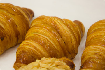 Three croissants on white background