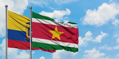 Ecuador and Suriname flag waving in the wind against white cloudy blue sky together. Diplomacy concept, international relations.