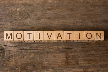 motivation word written on wooden toy cubes