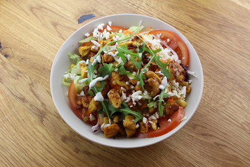 Delicious chicken salad in a white plate.