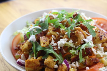 Delicious chicken salad in a white plate.