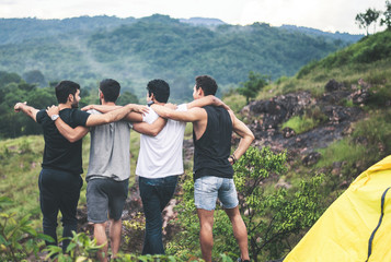 Cheerful young  man traveler friends hugging with hands raise up together at nature,Enjoying...