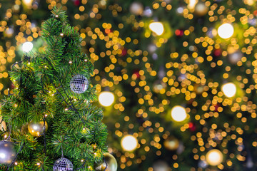 Obraz na płótnie Canvas Beautiful Christmas tree with decor against blurred bokeh lights in background.