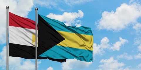 Egypt and Bahamas flag waving in the wind against white cloudy blue sky together. Diplomacy concept, international relations.