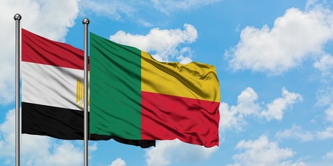 Egypt and Benin flag waving in the wind against white cloudy blue sky together. Diplomacy concept, international relations.