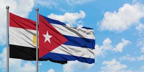 Egypt and Cuba flag waving in the wind against white cloudy blue sky together. Diplomacy concept, international relations.