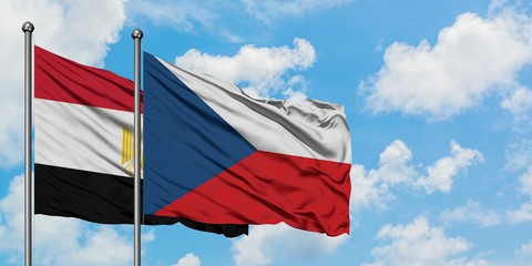 Egypt and Czech Republic flag waving in the wind against white cloudy blue sky together. Diplomacy concept, international relations.