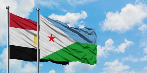 Egypt and Djibouti flag waving in the wind against white cloudy blue sky together. Diplomacy concept, international relations.