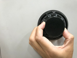Fototapeta premium Hand is rotating the security code of safe
