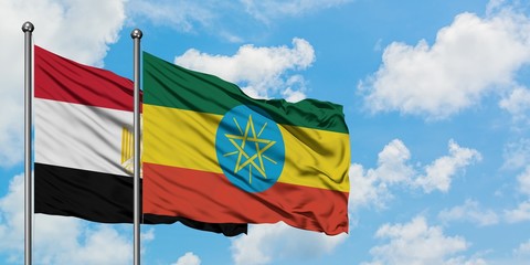 Egypt and Ethiopia flag waving in the wind against white cloudy blue sky together. Diplomacy concept, international relations.