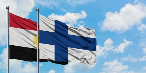 Egypt and Finland flag waving in the wind against white cloudy blue sky together. Diplomacy concept, international relations.