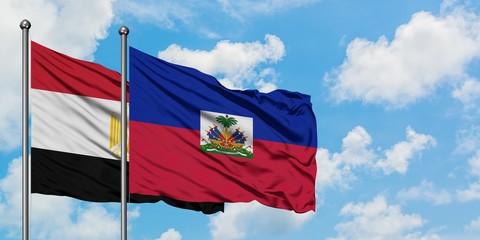 Egypt and Haiti flag waving in the wind against white cloudy blue sky together. Diplomacy concept, international relations.