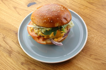 Delicious classic burger isolated on a white plate.