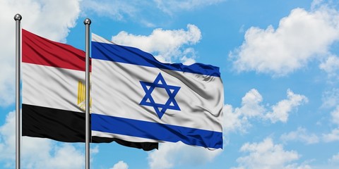 Egypt and Israel flag waving in the wind against white cloudy blue sky together. Diplomacy concept, international relations.