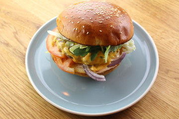 Delicious classic burger isolated on a white plate.