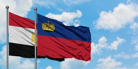 Egypt and Liechtenstein flag waving in the wind against white cloudy blue sky together. Diplomacy concept, international relations.