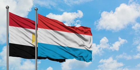 Egypt and Luxembourg flag waving in the wind against white cloudy blue sky together. Diplomacy concept, international relations.