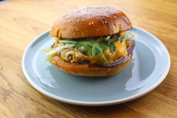 Delicious classic burger isolated on a white plate.