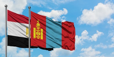 Egypt and Mongolia flag waving in the wind against white cloudy blue sky together. Diplomacy concept, international relations.