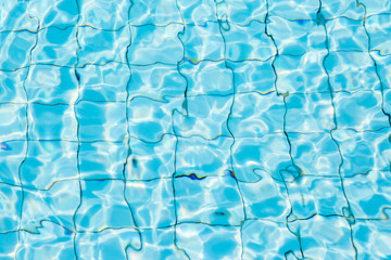 Water surface in blue swimming pool