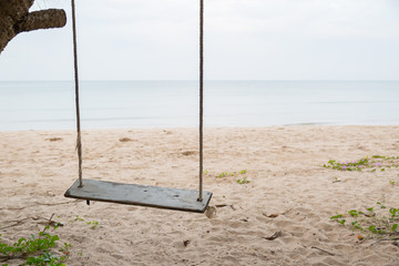 Wood swing at the beach and sand