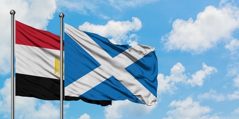 Egypt and Scotland flag waving in the wind against white cloudy blue sky together. Diplomacy concept, international relations.