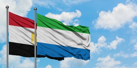 Egypt and Sierra Leone flag waving in the wind against white cloudy blue sky together. Diplomacy concept, international relations.