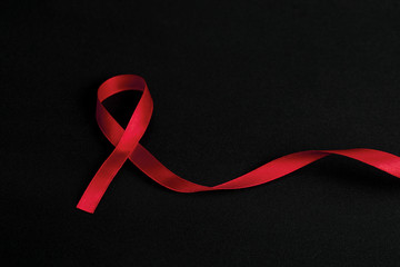 Red ribbon on palms and text 1st december world aids day, AIDS, HIV