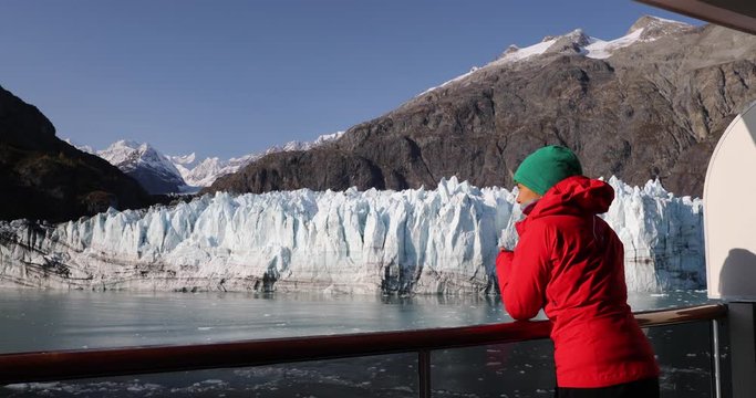 Alaska cruise ship passenger photographing glacier in Glacier Bay National Park, USA. Woman tourist taking photo picture using smart phone on travel vacation. Margerie Glacier.