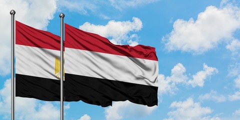 Egypt and Yemen flag waving in the wind against white cloudy blue sky together. Diplomacy concept, international relations.