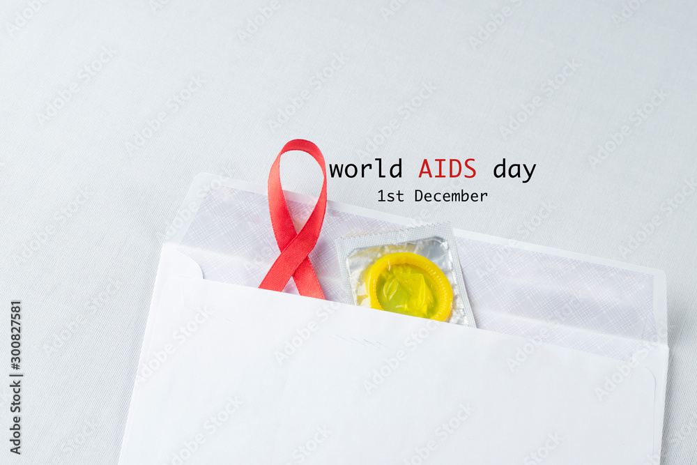 Wall mural red ribbon with a condom support for world aids day, aids, hiv