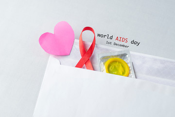 Red ribbon with a condom support for world aids day, AIDS, HIV