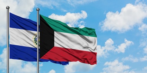 El Salvador and Kuwait flag waving in the wind against white cloudy blue sky together. Diplomacy concept, international relations.