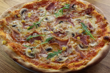 Calabrian pizza with ham, mushroom and cheese on a white plate.
