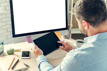 Office worker doing his job sitting at his working table with a computer