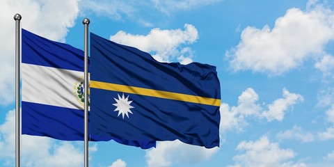 El Salvador and Nauru flag waving in the wind against white cloudy blue sky together. Diplomacy concept, international relations.
