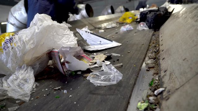 Workers on the conveyor of the waste processing plant. Recycling of garbage. Recycling and storage of waste for further disposal or reuse. 4k footage.