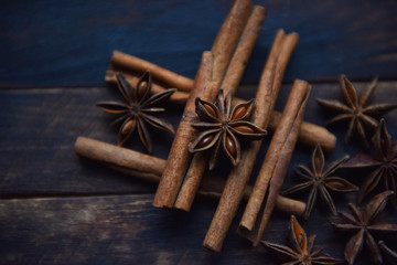Cassia sticks and star anise on a brown background